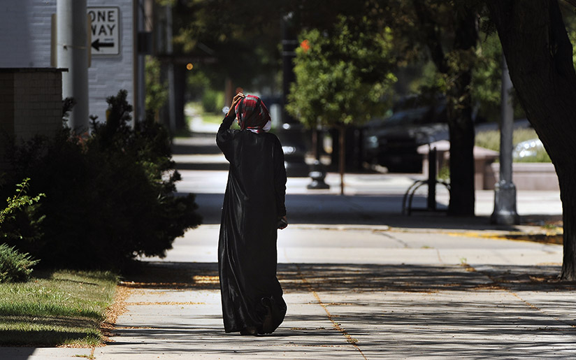 Photo of a Somali woman (wearing traditional clothing) walking
