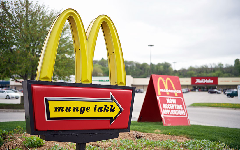 Photo of a sign saying “Mange takk” in Norwegian at a fast food restaurant, in Iowa